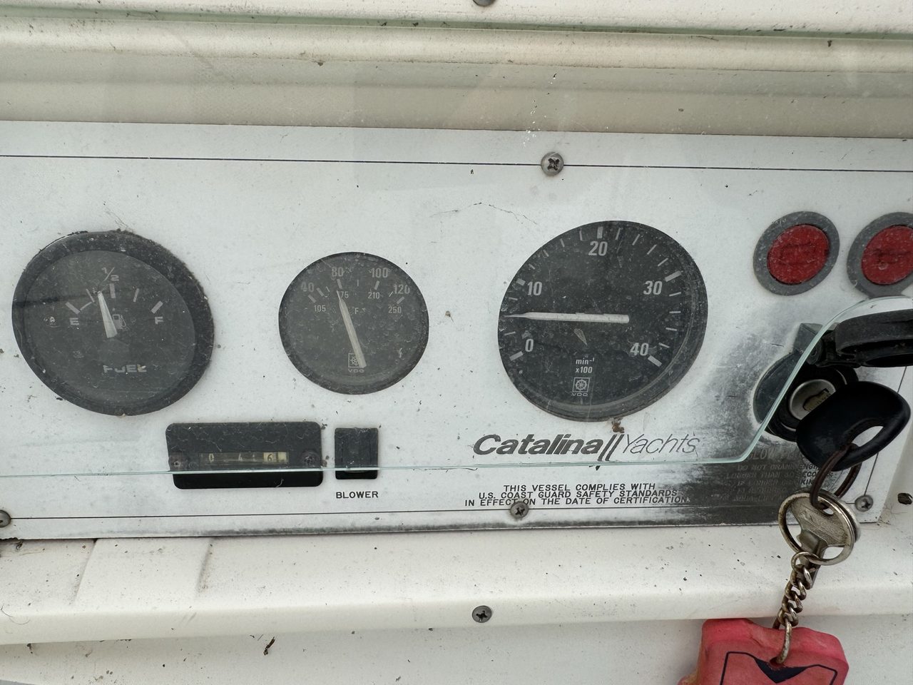 The worn original Catalina engine control panel with fuel and temperature gauges, tachometer, warning lights and ignition key