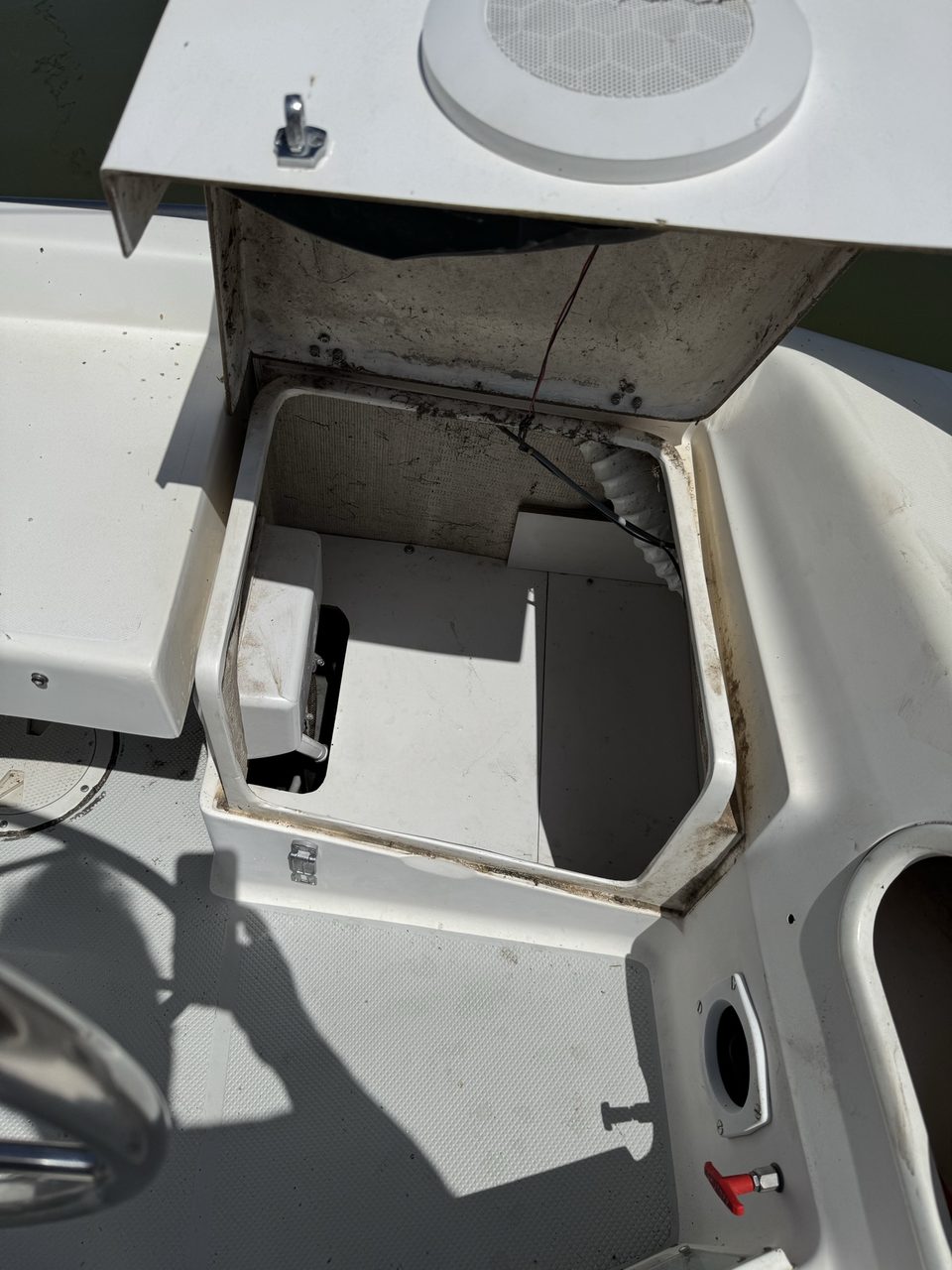 The same locker with its false bottom refitted, presenting a clean flat shelf with no wiring visible
