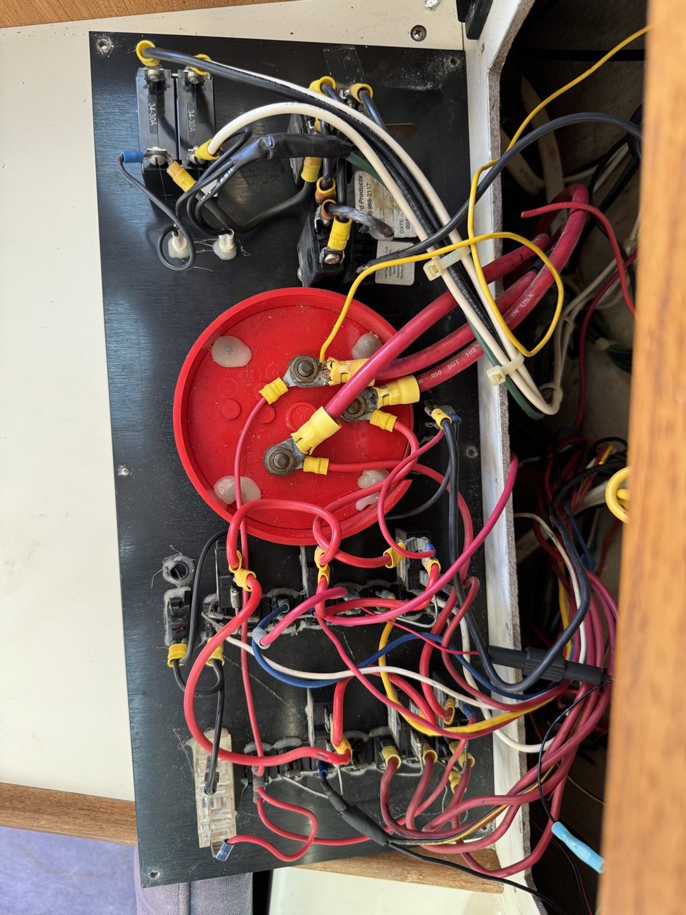 A dense collection of wires and terminals behind the original electrical panel