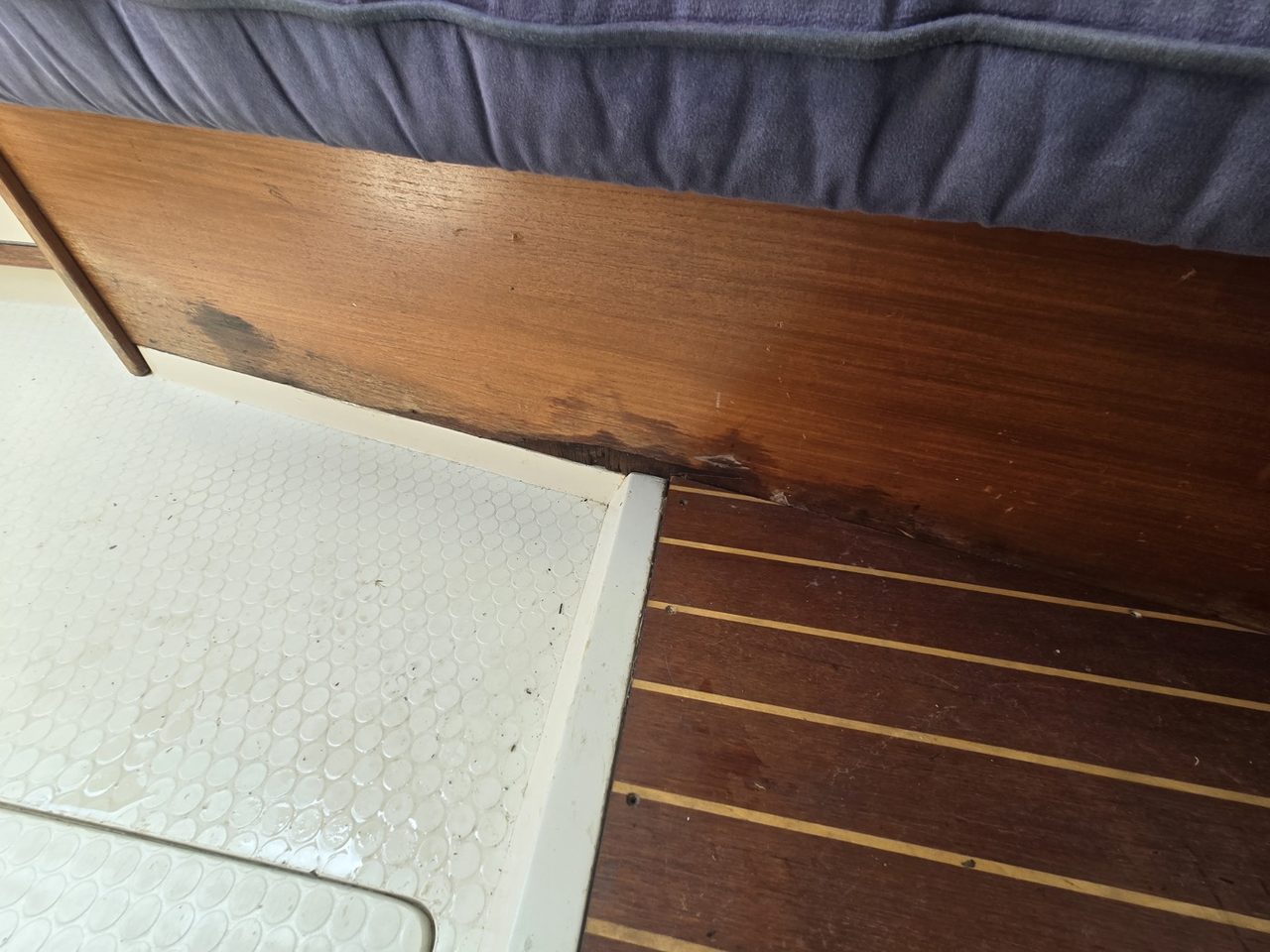 Water staining along the wooden trim at the bottom of the cabin