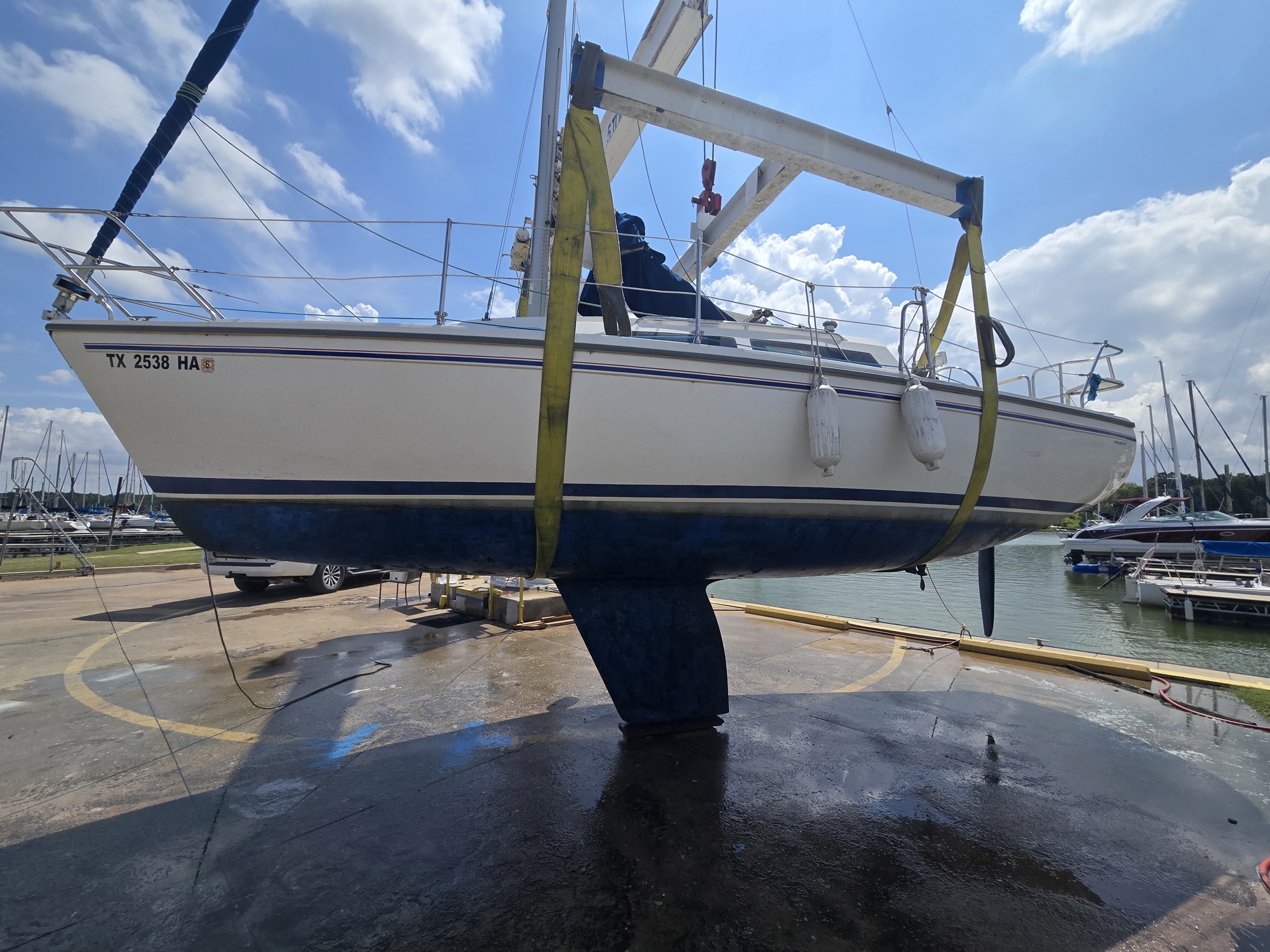 Out of the water for survey, June 2026. The five-foot fin keel is the deep version — good in open lake water, less forgiving in the shallow coves.