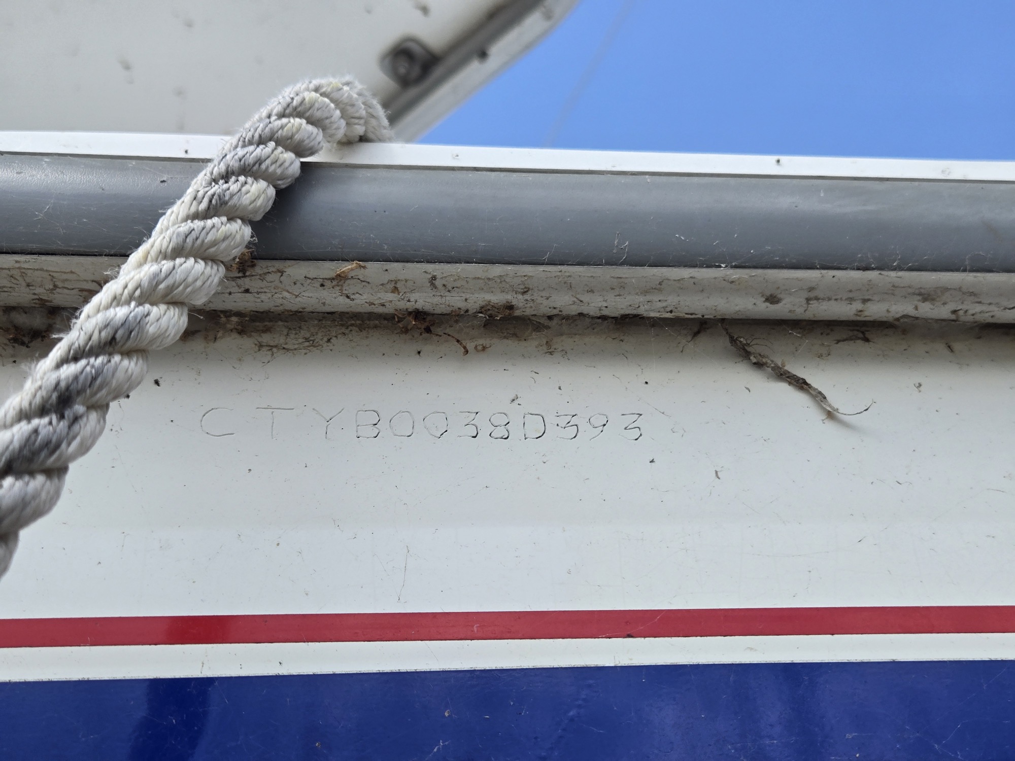 Hull identification number under the starboard rub rail. CTY for Catalina Yachts; D393 dates her to April 1993.