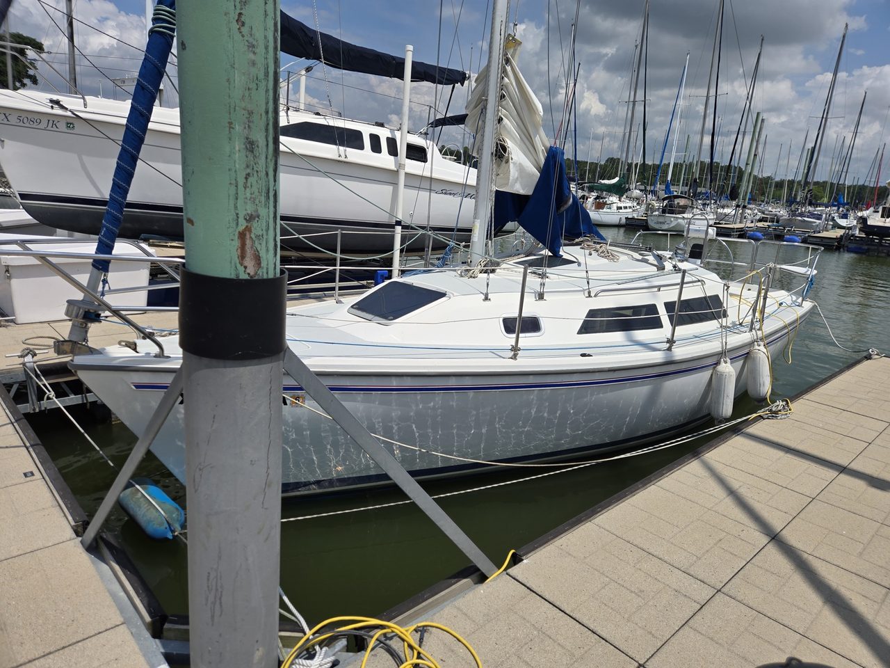 Swallow, a white Catalina 270 with a blue sheer stripe, lying alongside a floating dock at Oak Point